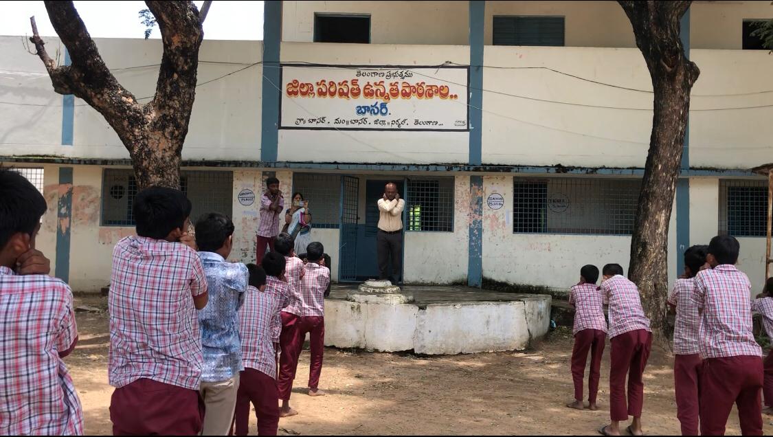 Head Master Sri Narsaiah performing Super Brain Yoga along with students at ZPHS, BASAR, Nirmal Dist.