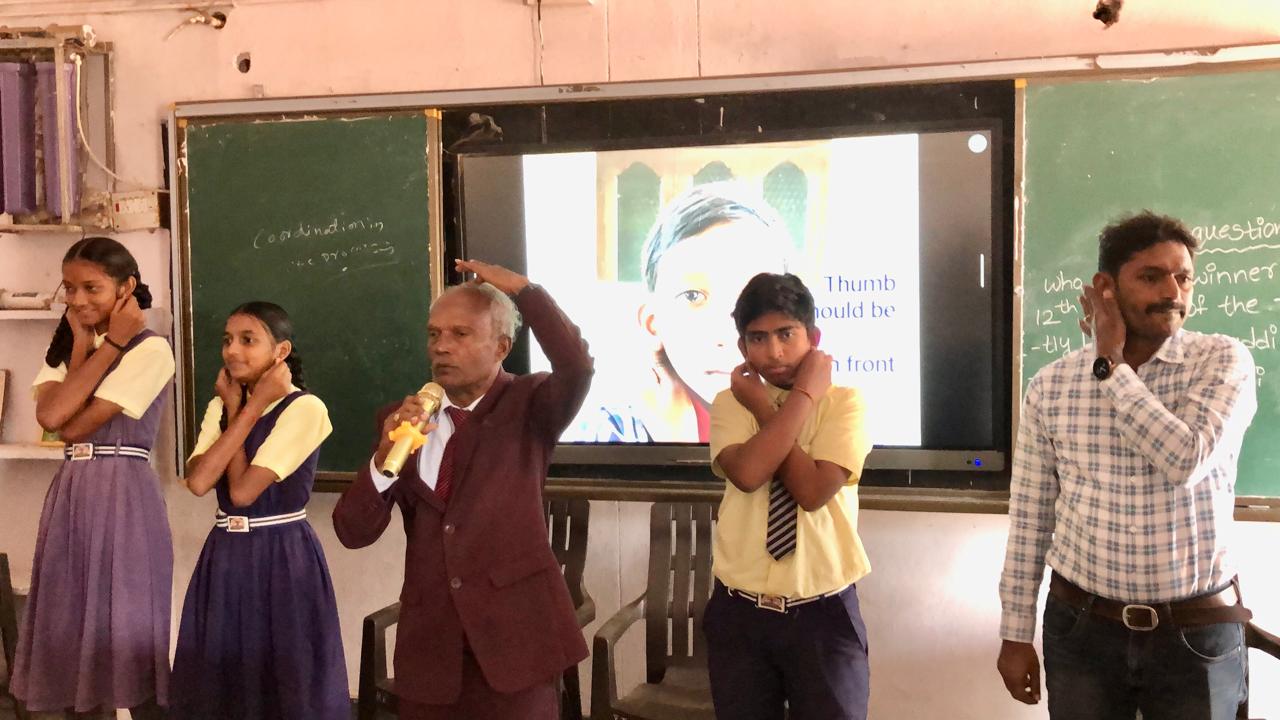 Positioning of arms on abdomen - Workshop on "Super Brain Yoga" at Zilla Parishad High School, Aloor, Nizamabad Dist.