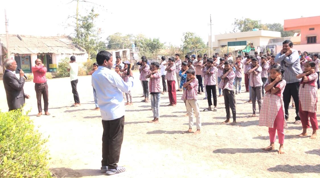 Positioning of arms on abdomen-Workshop on Super Brain Yoga at Zilla Parishad High School, Dhupally, Renjal Mandal.