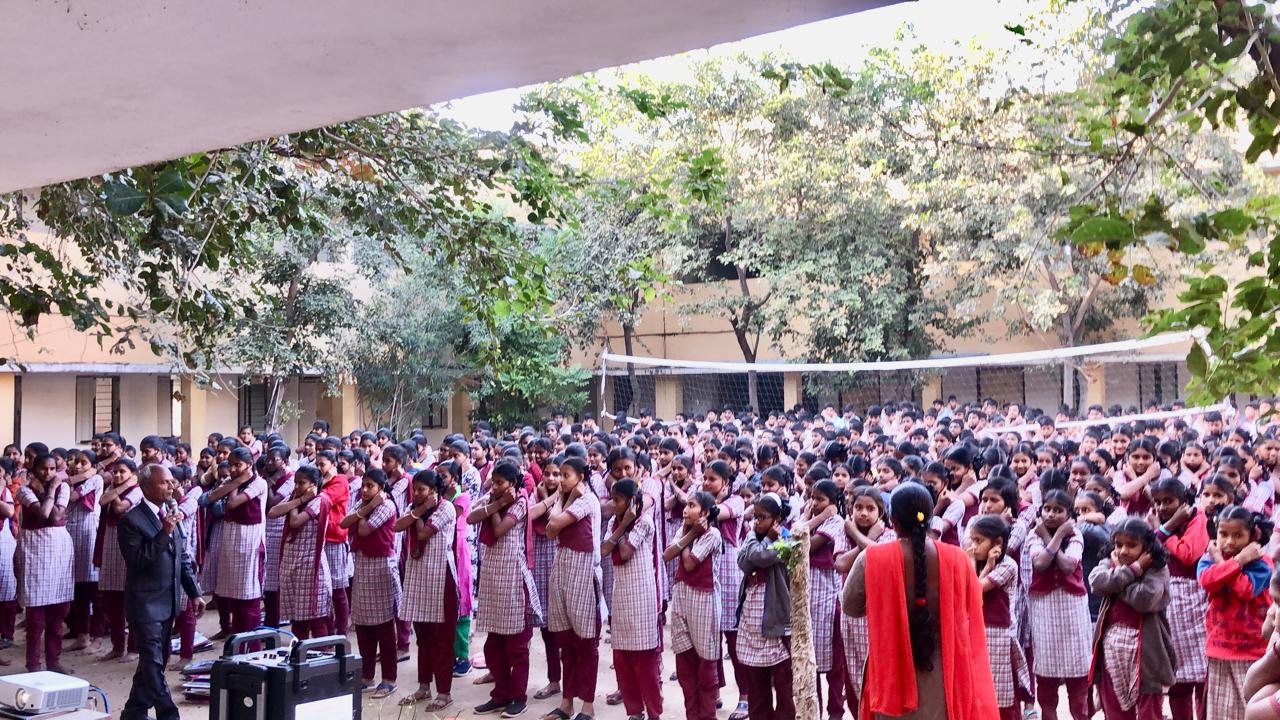 Positioning of fingers on earlobes and positioning of arms on abdomen during performing Super Brain Yoga at Model Junior College, Amadabakula, Kottakota, Wanaparthi Dist.