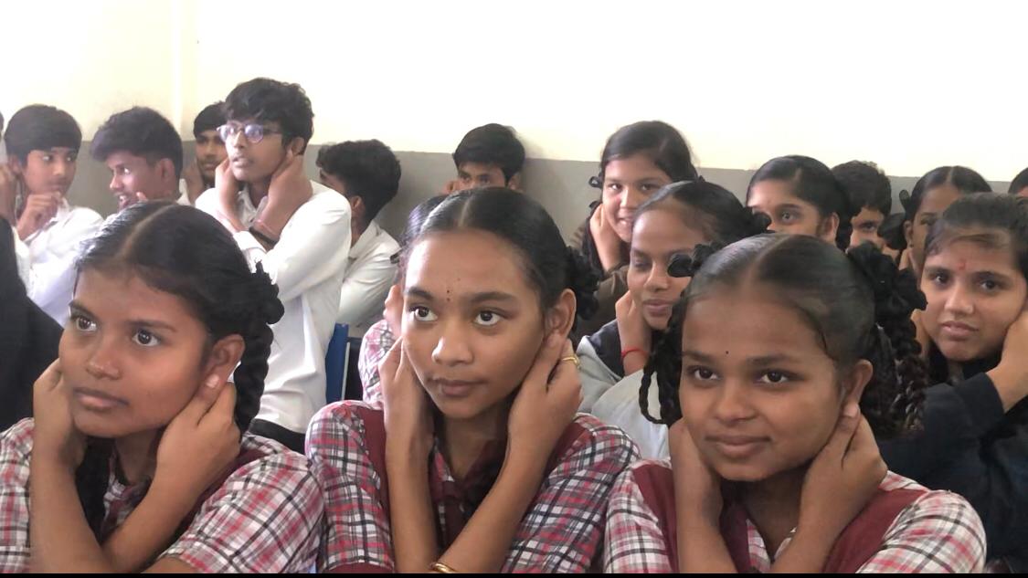 Positioning of fingers on earlobes-Workshop on Super Brain Yoga at Zilla Parishad High School, Qutbullapur, Medchal-Malkajgiri Dist.