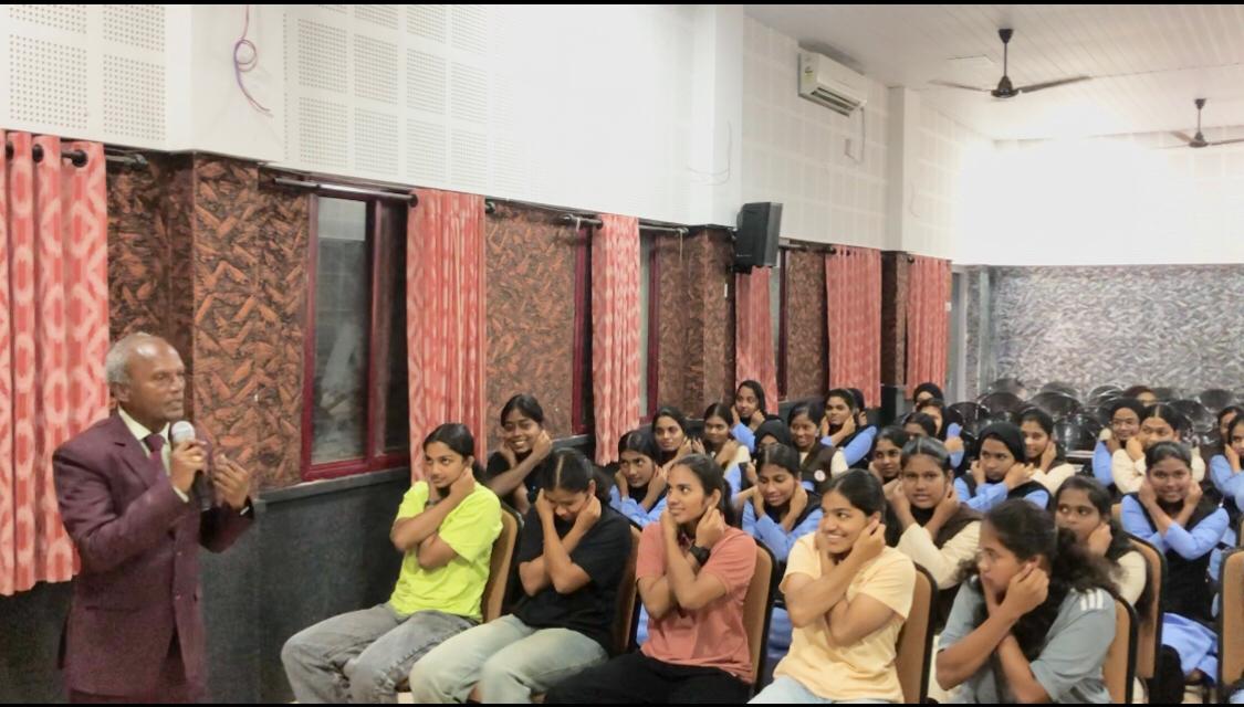 Positioning of fingers on earlobes during performing  Super Brain Yoga at MES Ponnani College, Ponnani, Kerala state.