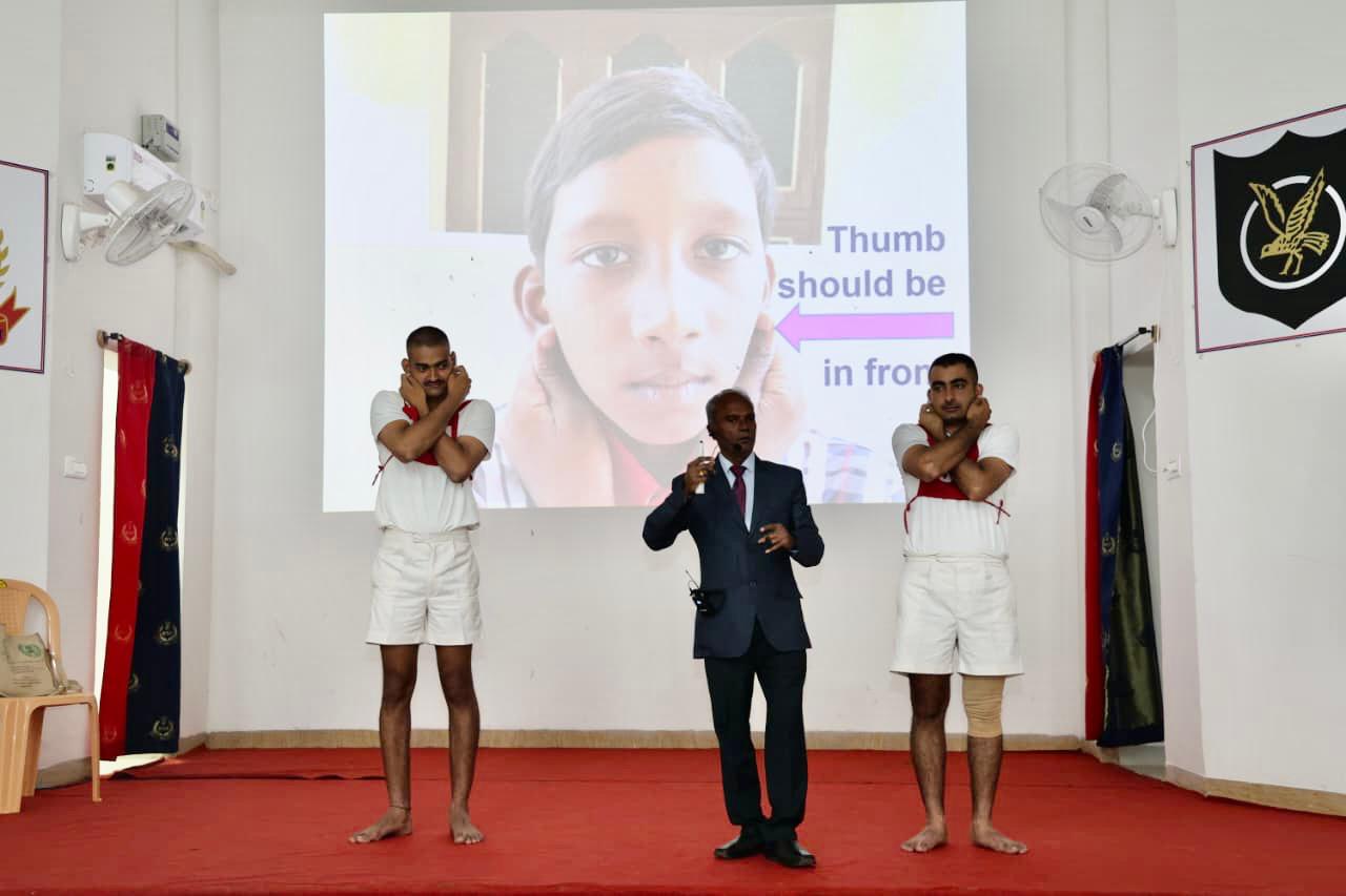 Positioning of fingers on earlobes-Super Brain Yoga at Border Security Force (STC), Yelhanka, Bangalore, Karnataka state.